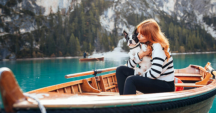 Woman with dog in a boat